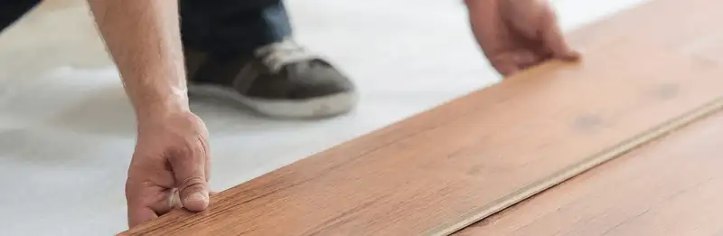 A professional installing laminate flooring in Richmond, VA